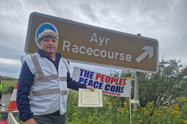 Nick, from 'the people's peace core' standing at one of the blocked off roads leading to Turnberry Hotel
