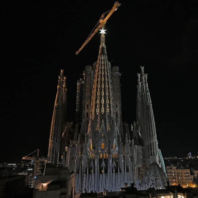 The new star atop the Sagrada Familia basilica's tower of Virgin Mary shines during the inauguration. Credit: Getty
