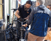 Dion Owen fixes a bike to be handed out to a Fringe performer.