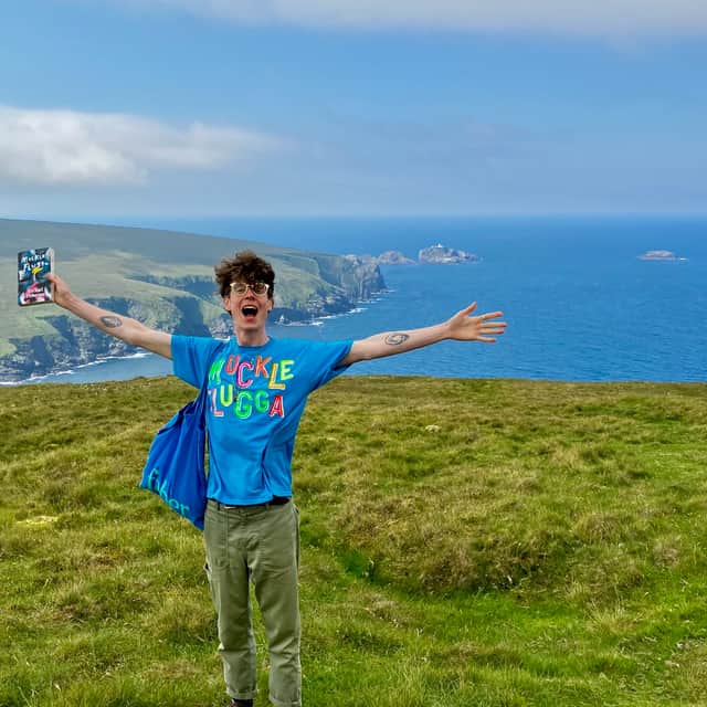 Author Michael Pedersen in the Shetland Islands with Muckle Flugga and its lighthouse in the distance.