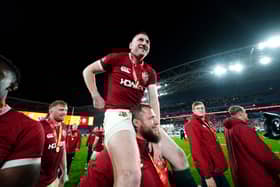 British and Irish Lions' Finn Russell celebrates on the shoulders of Pierre Schoeman after winning the series against Australia.