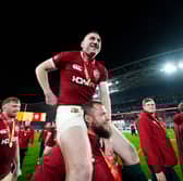 British and Irish Lions' Finn Russell celebrates on the shoulders of Pierre Schoeman after winning the series against Australia.