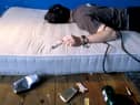 A heroin addict lies sprawled on a mattress (Picture: Chris Young)