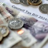 Money stacked on top of a council tax bill