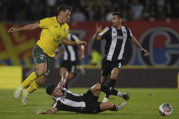 Hibs' Josh Mulligan, left, duels for the ball with Partizan's Milan Vukotic.