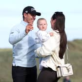 Grant Forrest celebrates with his wife Christy and son Spencer  on the 18th green, after winning the Nexo Championship at Trump International Golf Links