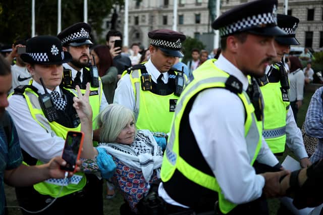 A protester is carried away by police officers at a 'Lift The Ban' demonstration in support of the proscribed group Palestine Action (Picture: Henry Nicholls)