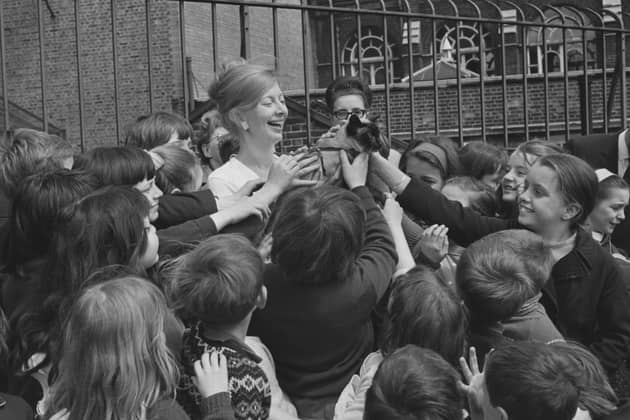 Biddy Baxter, editor of BBC show Blue Peter, with a group of schoolchildren and the show's cat Jason in 1966 (Picture: Len Trievnor/Express/Hulton Archive)