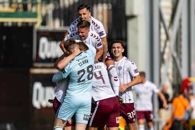 The Hearts players celebrate their win over Dundee United at Tannadice.