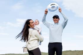 Grant Forrest shows off the Nexo Championship trophy as he celebrates his second DP World Tour win with wife Christy and son Spencer at Trump International Golf Links 