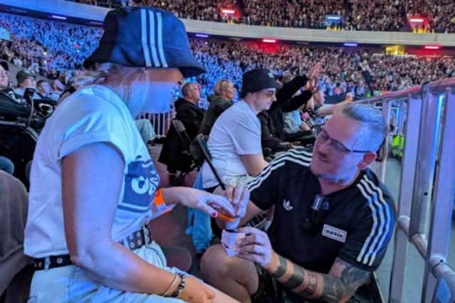 Dwayne Yuill proposing to his partner of six years, Shell Hodge at the first of Oasis's three nights in Edinburgh on August 8.