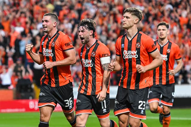 Dundee United's Max Watters (L) celebrates with Will Ferry (C) and Krisztian Keresztes (R) after scoring from the penalty spot to make it 2-0 over Rapid Vienna. (Photo by Paul Devlin / SNS Group)