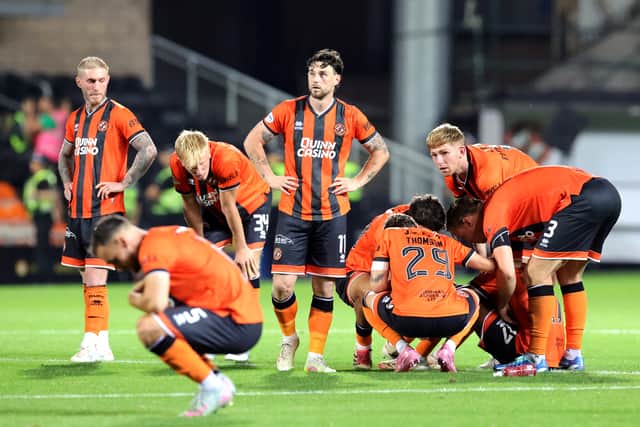 Dundee United players look dejected after defeat in the penalty shoot-out to Rapid Vienna.
