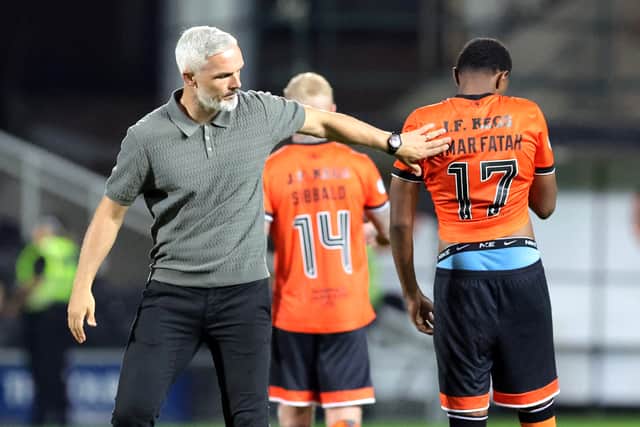 Dundee United's Amar Fatah is consoled by manager Jim Goodwin following defeat in the penalty shoot-out to Rapid Vienna.
