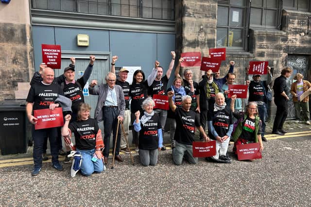 Ken Loach posing with activists after an event at the Edinburgh International Film Festival