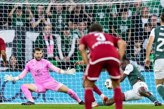 Hibs defender Rocky Bushiri handles the ball in the box, conceding a penalty following a VAR check.  (Photo by Ross Parker / SNS Group)