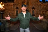 Sam Heughan pictured outside the entrance of Edinburgh Castle.