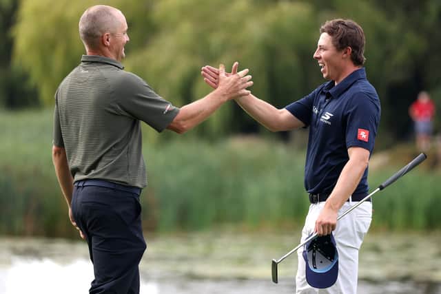 Alex Noren is congratulated by overnight leader Matt Fitzpatrick  on the 18th green after landing a second win in the Betfred British Masters hosted by Sir Nick Faldo 