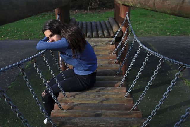 A teenage girl in a park showing signs of mental health issues. Picture: Gareth Fuller/PA Wire
