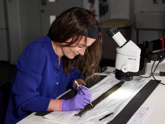 Conservator Bethan Bryan working on the Carnoustie Hoard