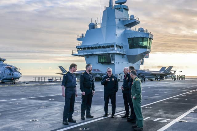Keir Starmer and Defence Secretary John Healey with Armed Forces personnel on board aircraft carrier HMS Prince of Wales (Picture: Richard Pohle/pool)