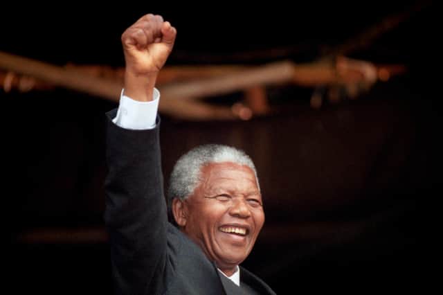Nelson Mandela acknowledges the crowd at a rally in Glasgow in October 1993
