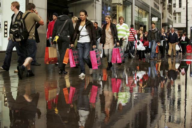 People walk past a Topshop and Topman store on Oxford Street in October 2006 (Photo: Scott Barbour/Getty Images)
