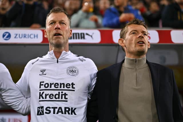 Assistant coach Morten Wieghorst (left) with Denmark's acting head coach Lars Knudsen during the national athems prior to a match against Switzerland in October last year. (Photo by FABRICE COFFRINI/AFP via Getty Images)