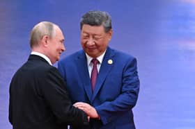 All smiles. Vladimir Putin and Xi Jinping shake hands during the Russian dictator's visit to China (Picture: Sergei Bobylyov/pool)
