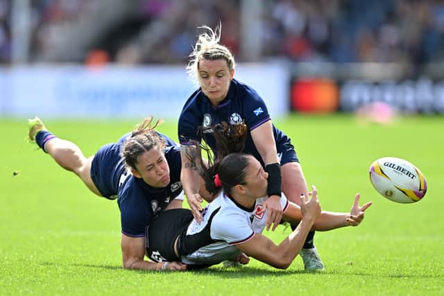 Florence Symonds of Canada is tackled by Rhona Lloyd of Scotland.