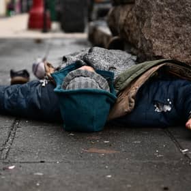 A man lies in the street in Portland, Oregon, after the authorities decriminalised all drugs (Picture: Patrick T Fallon)