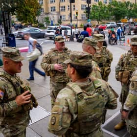 National Guard troops from South Carolina stand outside the Foggy Bottom Metro Station in Washington DC last month, after Donald Trump ordered them onto the streets of the US capital (Picture: Andrew Harnik)