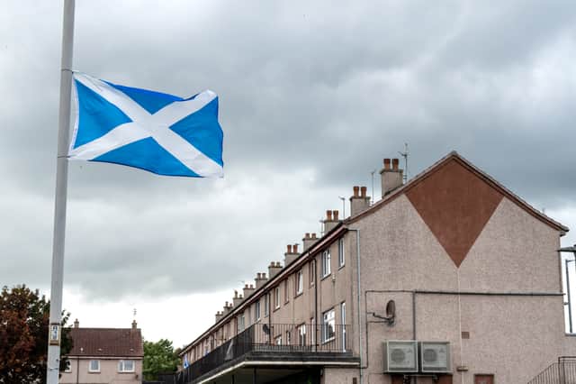 A saltire flies from a lamppost in Paisley (Picture: John Devlin)