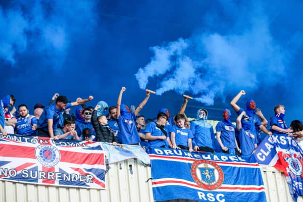 Rangers fans hold up blue pyrotechnics during the William Hill Premiership season opener at Motherwell. (Photo by Alan Harvey / SNS Group)