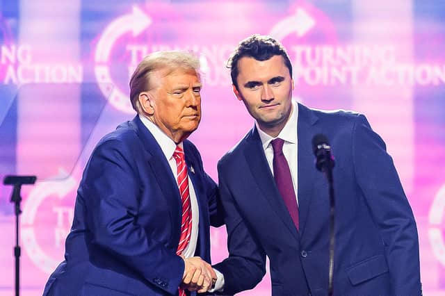 Charlie Kirk shakes hands with Donald Trump during an event in Phoenix, Arizona, last year (Picture: Josh Edelson)