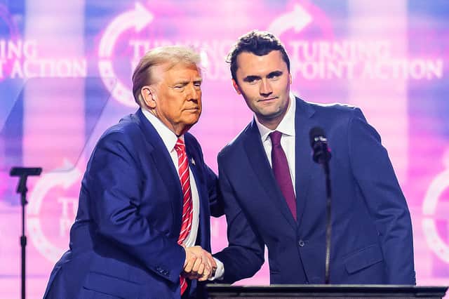 Charlie Kirk shakes hands with Donald Trump during an event in Phoenix, Arizona, last year (Picture: Josh Edelson)