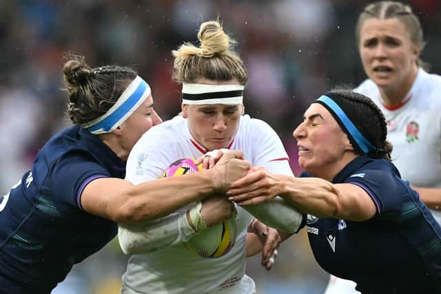 England centre Megan Jones (C) battles through the Scotland defence during the Women's Rugby World Cup quarter-final. (Photo by PAUL ELLIS/AFP via Getty Images)