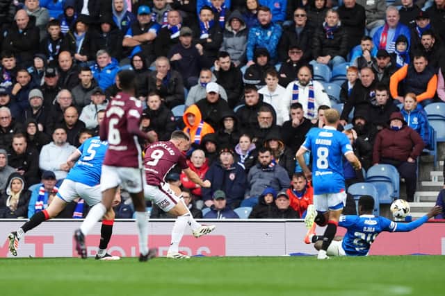 Lawrence Shankland, No 9, opens the scoring during Hearts' 2-0 win over Rangers in the Premiership at Ibrox Stadium.