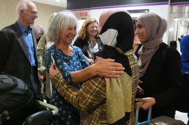 Lorna Norgrove, mother of the late aid worker Linda Norgrove, greets a group of 19 women from Afghanistan at Edinburgh Airport. They came to Scotland to complete their medical degrees after women were banned from education by the Taliban (Picture: Andrew Milligan)
