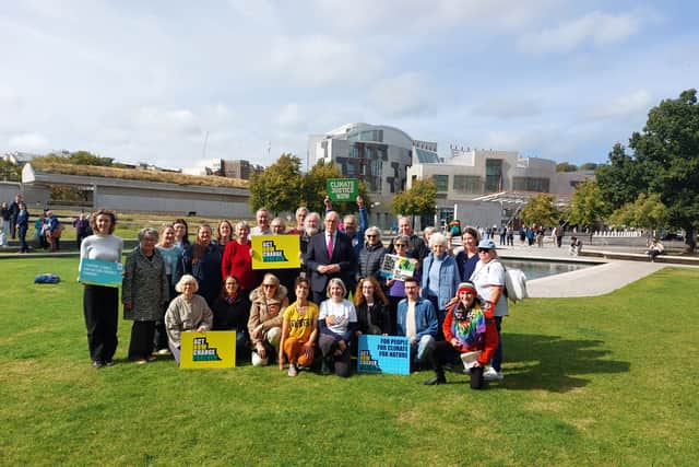 First Minister John Swinney with Stop Climate Chaos campaigners outside the Scottish Parliament.