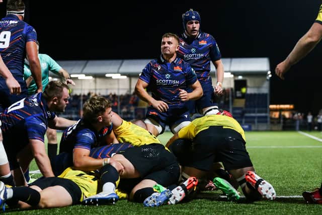 Edinburgh's Ben Vellacott, centre, celebrates as his side score their third try during a pre-season match against Ealing Trailfinders.