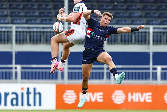 Edinburgh's Nairn Moncrieff (L) in action against Doncaster Knights.