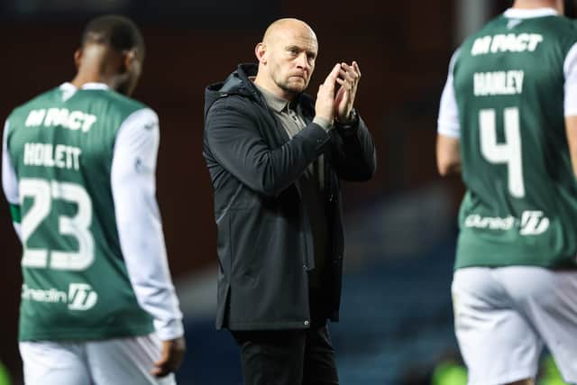 Hibs head coach David Gray applauds the travelling support after the defeat by Rangers.