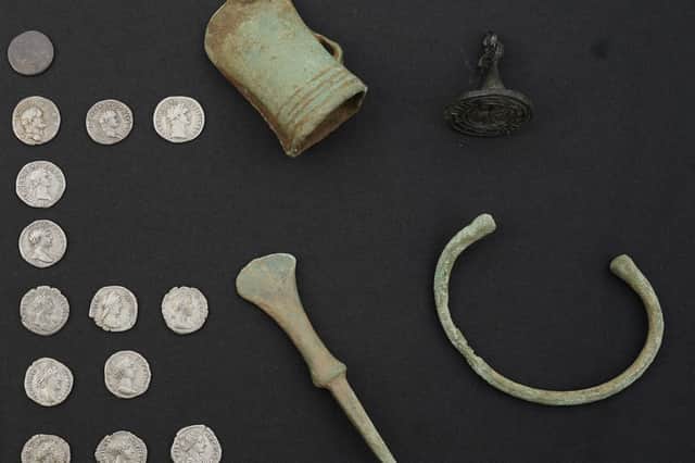 A collection of Roman coins, axehead and bracelet recently recorded by the Treasure Trove Unit. PIC: Stewart Attwood.