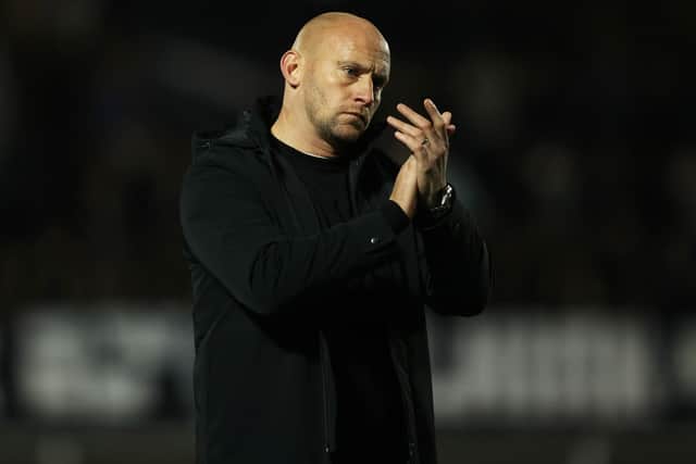 Hibs head coach David Gray applauds the fans at full time.