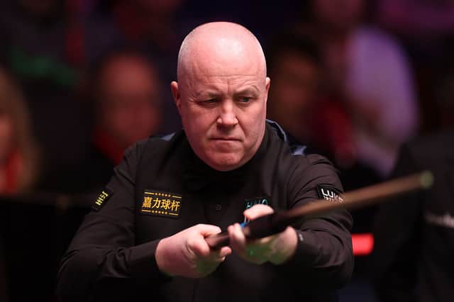 John Higgins is safely through to the second round of the British Open.