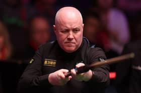 John Higgins is safely through to the second round of the British Open.