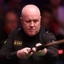 John Higgins is safely through to the second round of the British Open.