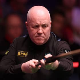 John Higgins is safely through to the second round of the British Open.