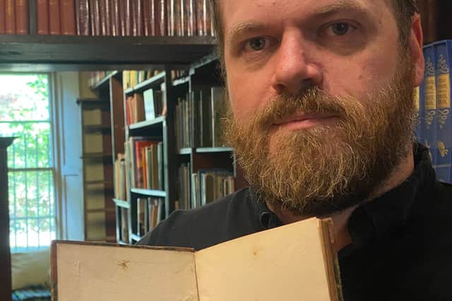 Derek Walker pictured with the book.